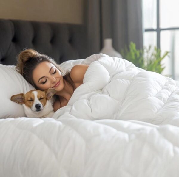 a woman laying on white comforter