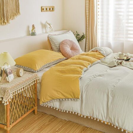 white and yellow pom pom bedding set